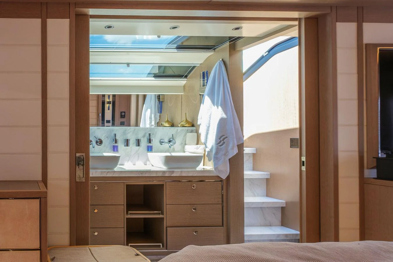 This image showcases a luxurious yacht bathroom with elegant fixtures and ample natural light. aboard 2024 SIRENA 88 Yacht for Sale