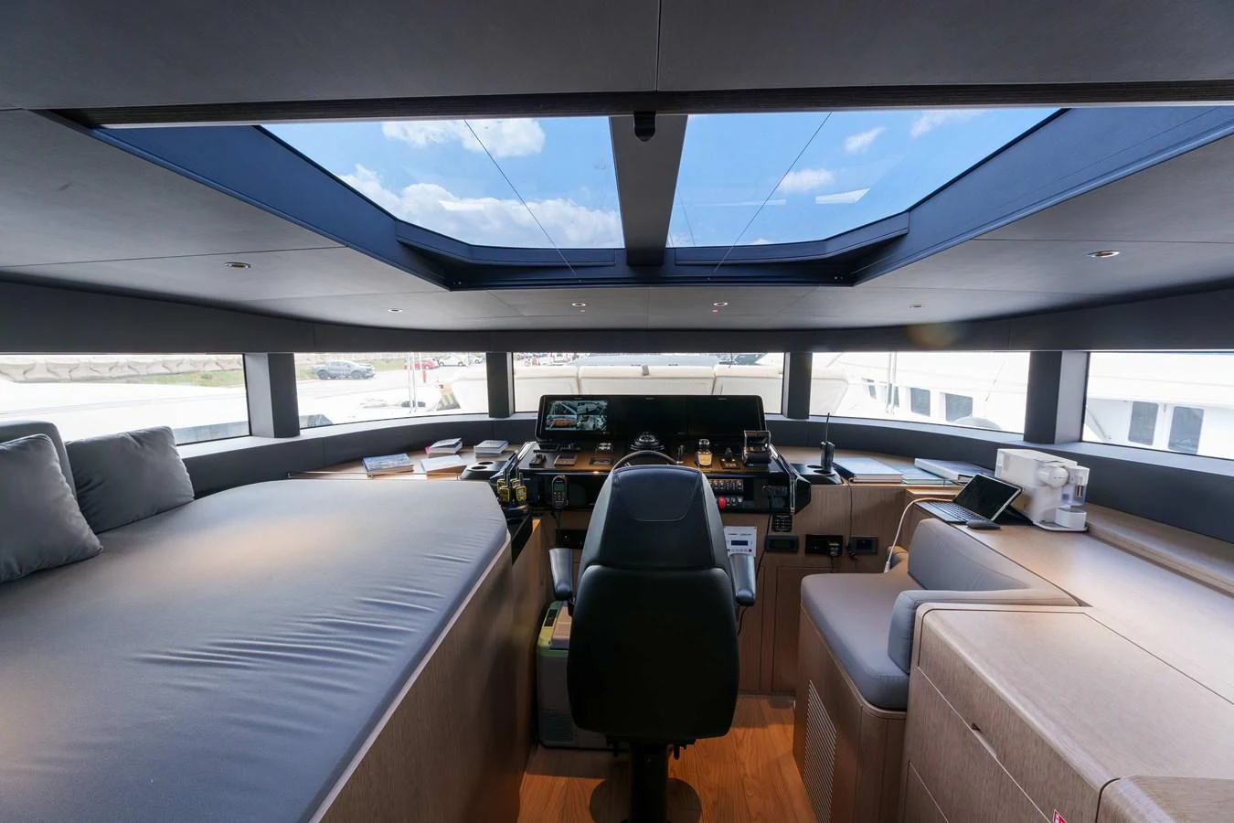 The helm station offers a panoramic view with modern controls and comfortable seating. aboard 2024 SIRENA 88 Yacht for Sale