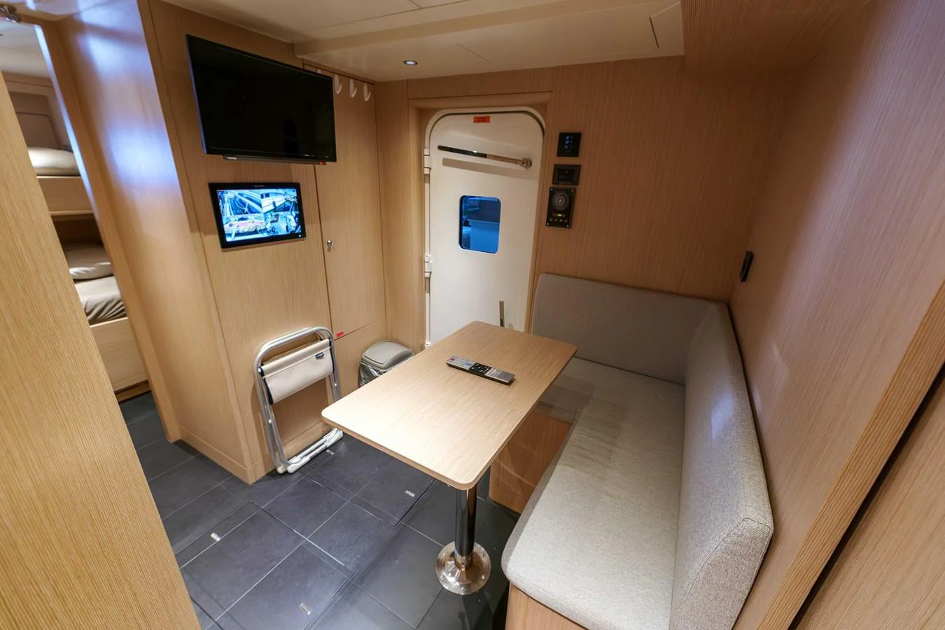The cozy interior features a small dining area with a table and bench seating, complemented by modern amenities. aboard 2024 SIRENA 88 Yacht for Sale