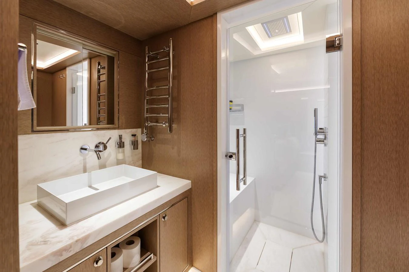 The yacht's bathroom features a modern design with a sleek sink and a spacious shower area. aboard 2024 SIRENA 88 Yacht for Sale