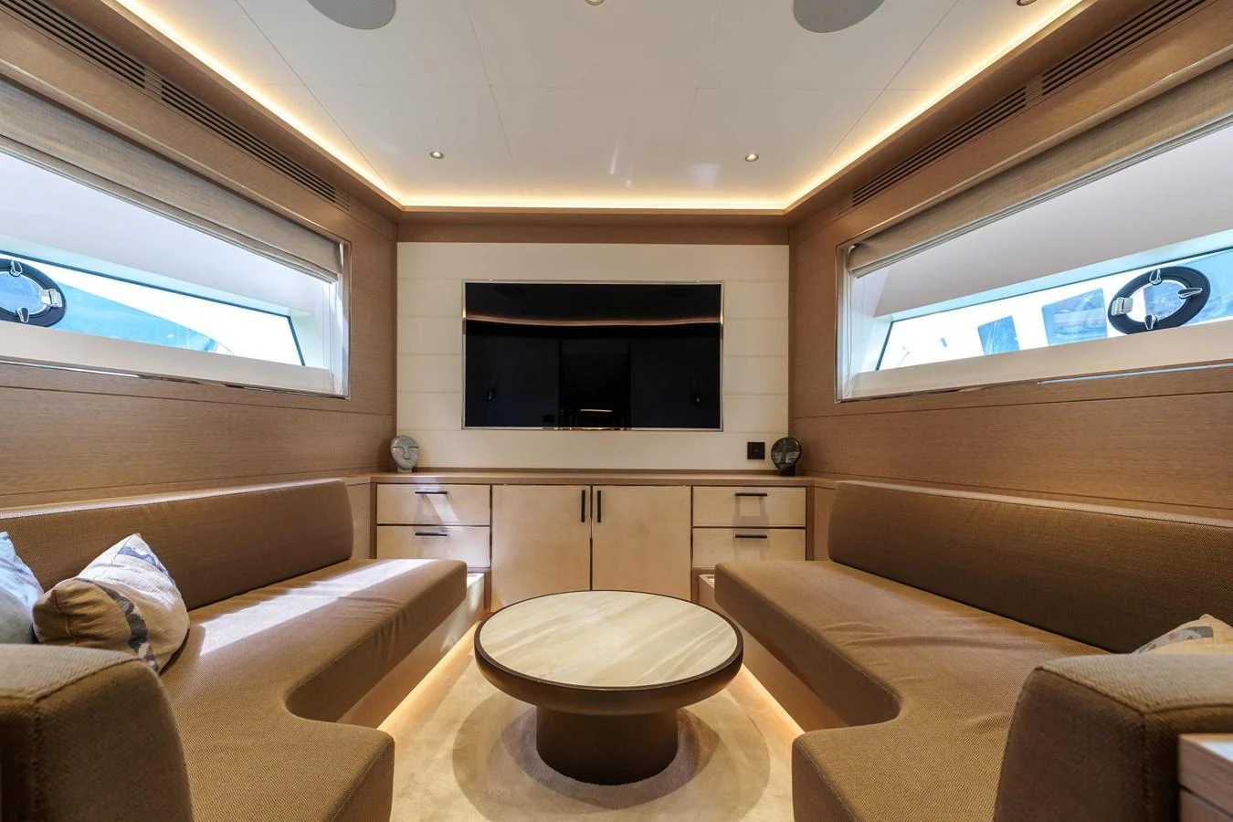 The salon features a cozy seating area with a central coffee table and large windows for natural light. aboard 2024 SIRENA 88 Yacht for Sale