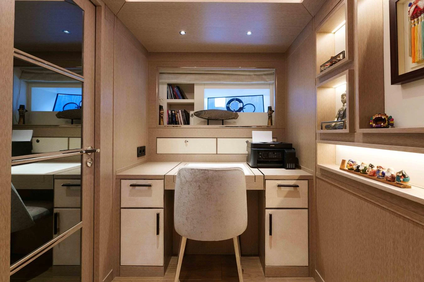 This image showcases a well-appointed office space within the yacht, featuring a desk, chair, and ample storage. aboard 2024 SIRENA 88 Yacht for Sale