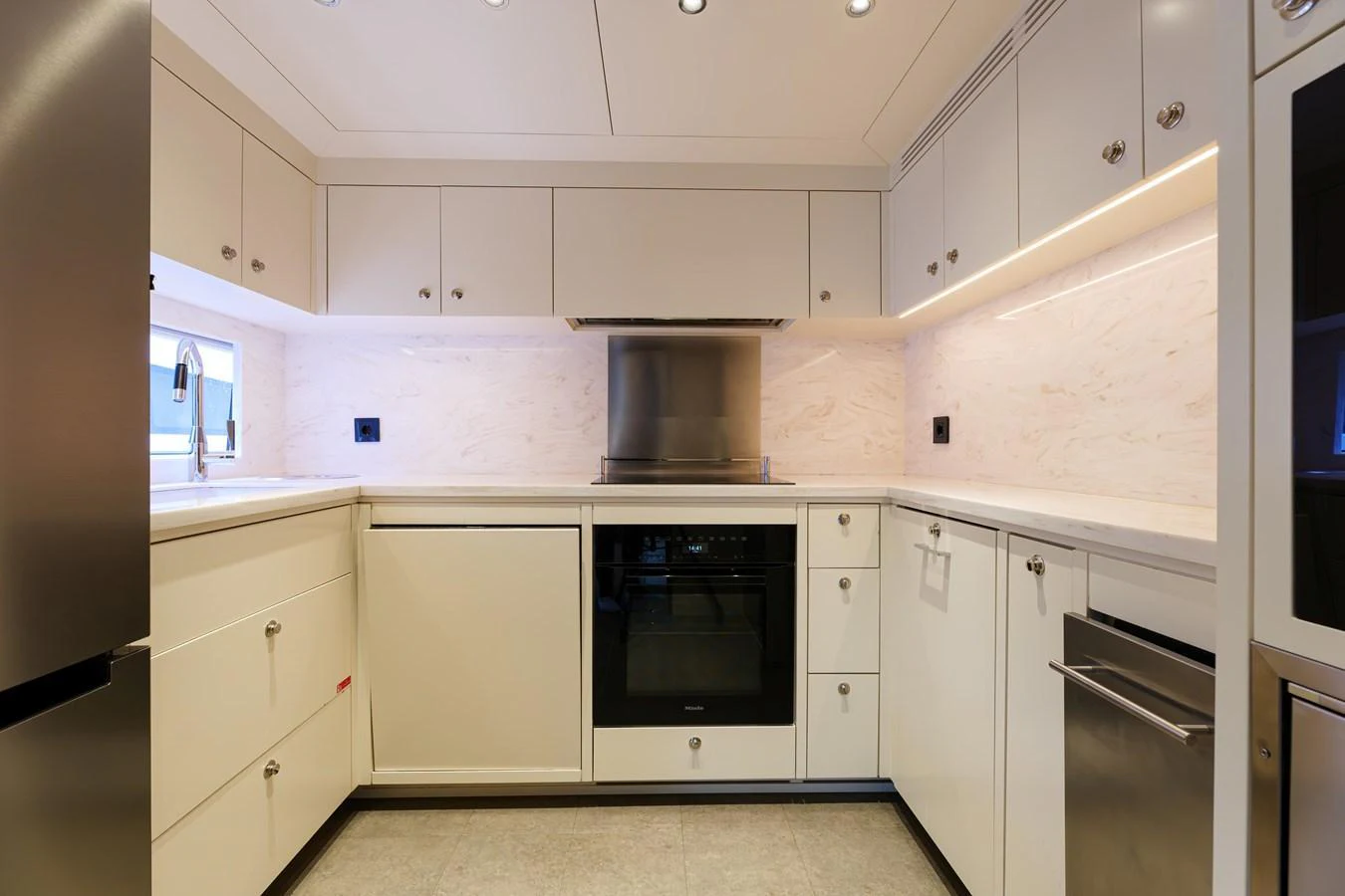 The yacht's galley is equipped with modern appliances and sleek cabinetry, offering a functional and stylish cooking space. aboard 2024 SIRENA 88 Yacht for Sale