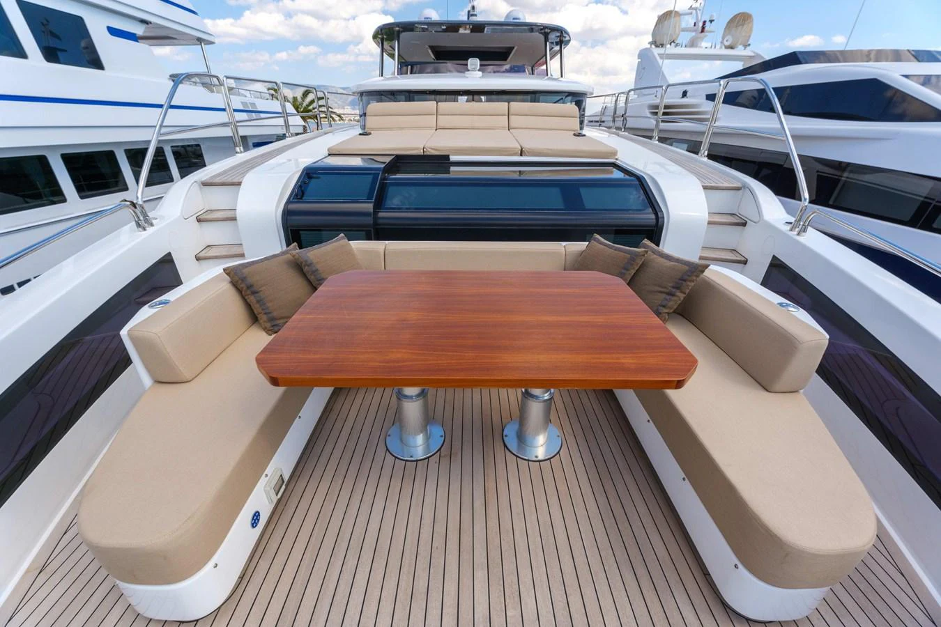 The foredeck features a stylish seating area with a wooden table, perfect for outdoor relaxation. aboard 2024 SIRENA 88 Yacht for Sale