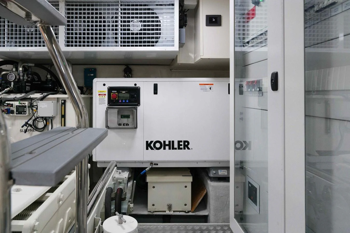 The image showcases the engine room with a Kohler generator and various mechanical components. aboard 2024 SIRENA 88 Yacht for Sale