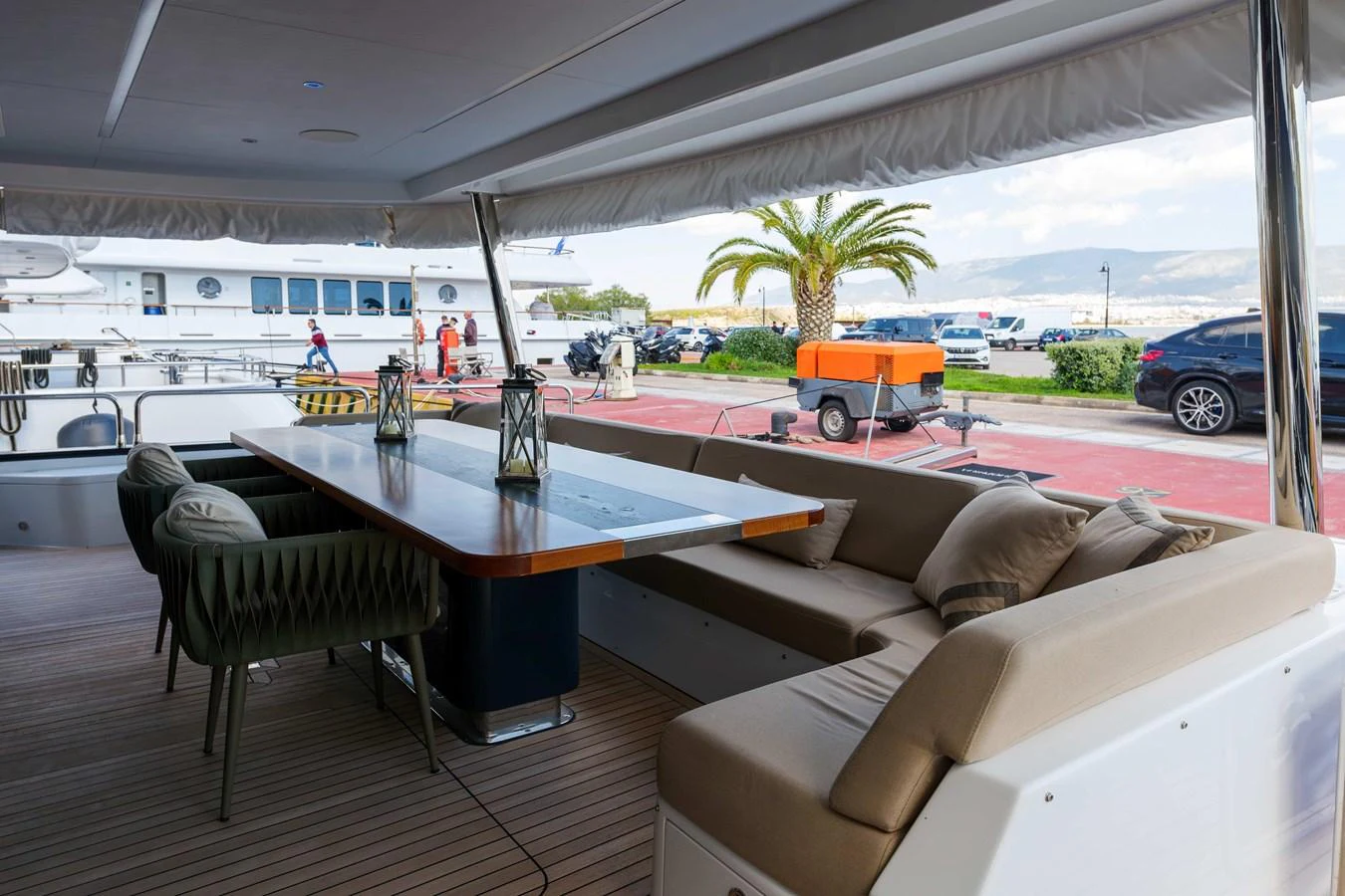 The aft deck features a comfortable dining area with a large table and cushioned seating, perfect for alfresco meals. aboard 2024 SIRENA 88 Yacht for Sale