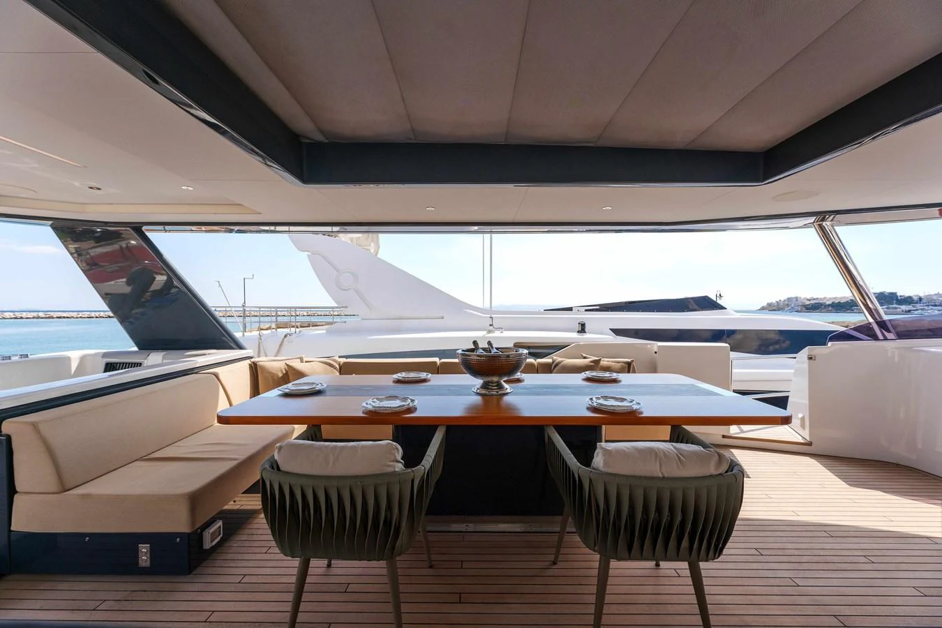 The aft deck features a stylish dining area with a large table and comfortable seating, perfect for alfresco meals. aboard 2024 SIRENA 88 Yacht for Sale
