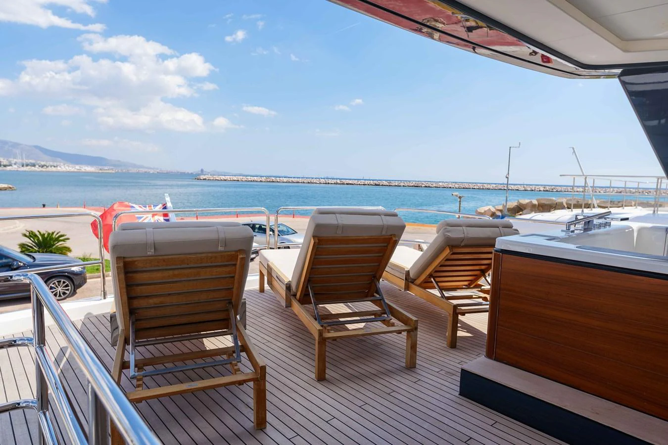 The sundeck offers a relaxing space with lounge chairs and a stunning view of the sea. aboard 2024 SIRENA 88 Yacht for Sale