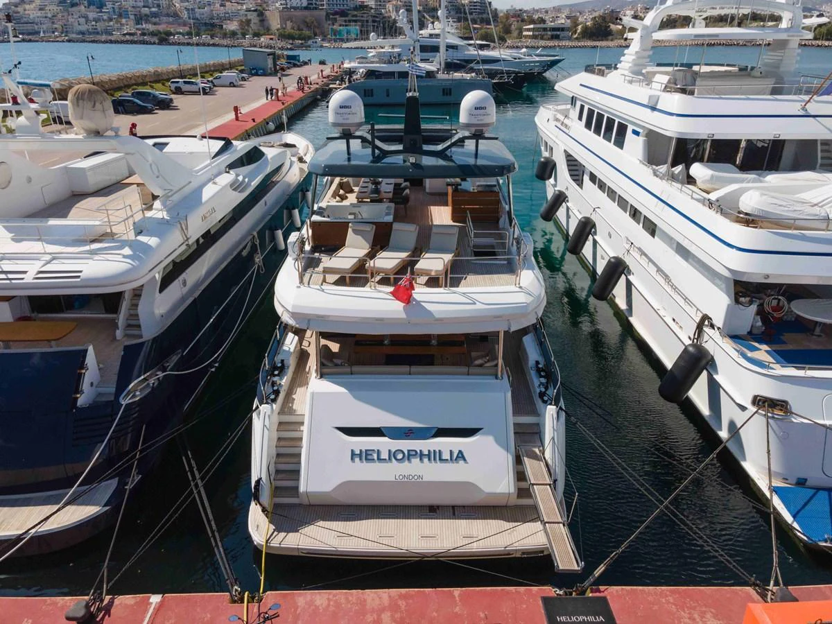 The yacht is docked at a marina, showcasing its spacious aft deck and luxurious amenities. aboard 2024 SIRENA 88 Yacht for Sale