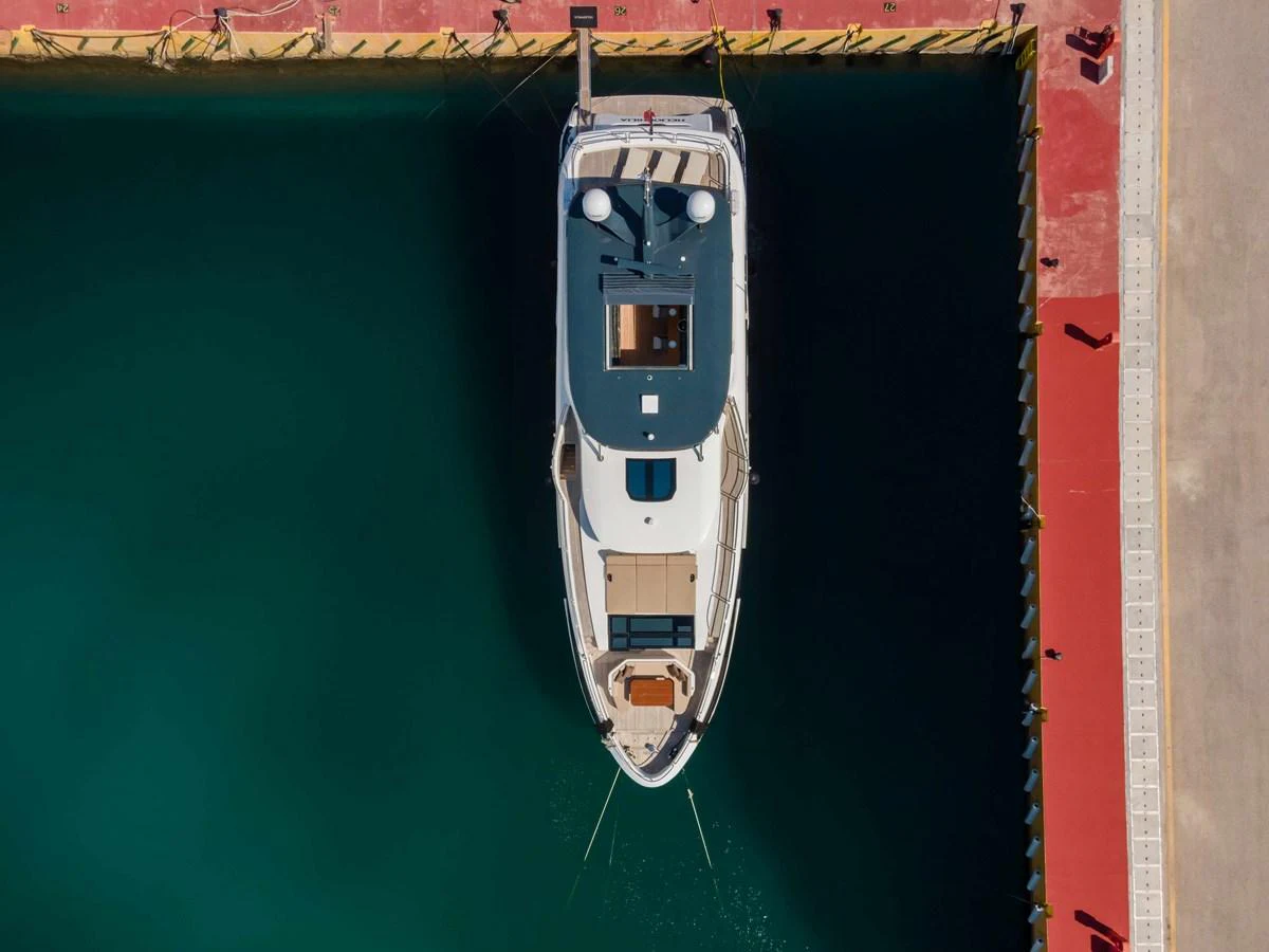 Aerial view of a yacht docked at a marina, showcasing its sleek design and spacious deck areas. aboard 2024 SIRENA 88 Yacht for Sale