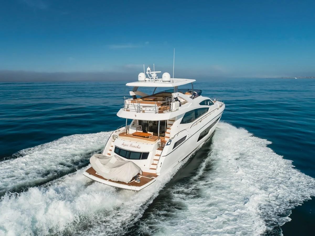 A luxurious yacht cruises through the open water, showcasing its sleek design and spacious decks. aboard AGUA RANCHO Yacht for Sale