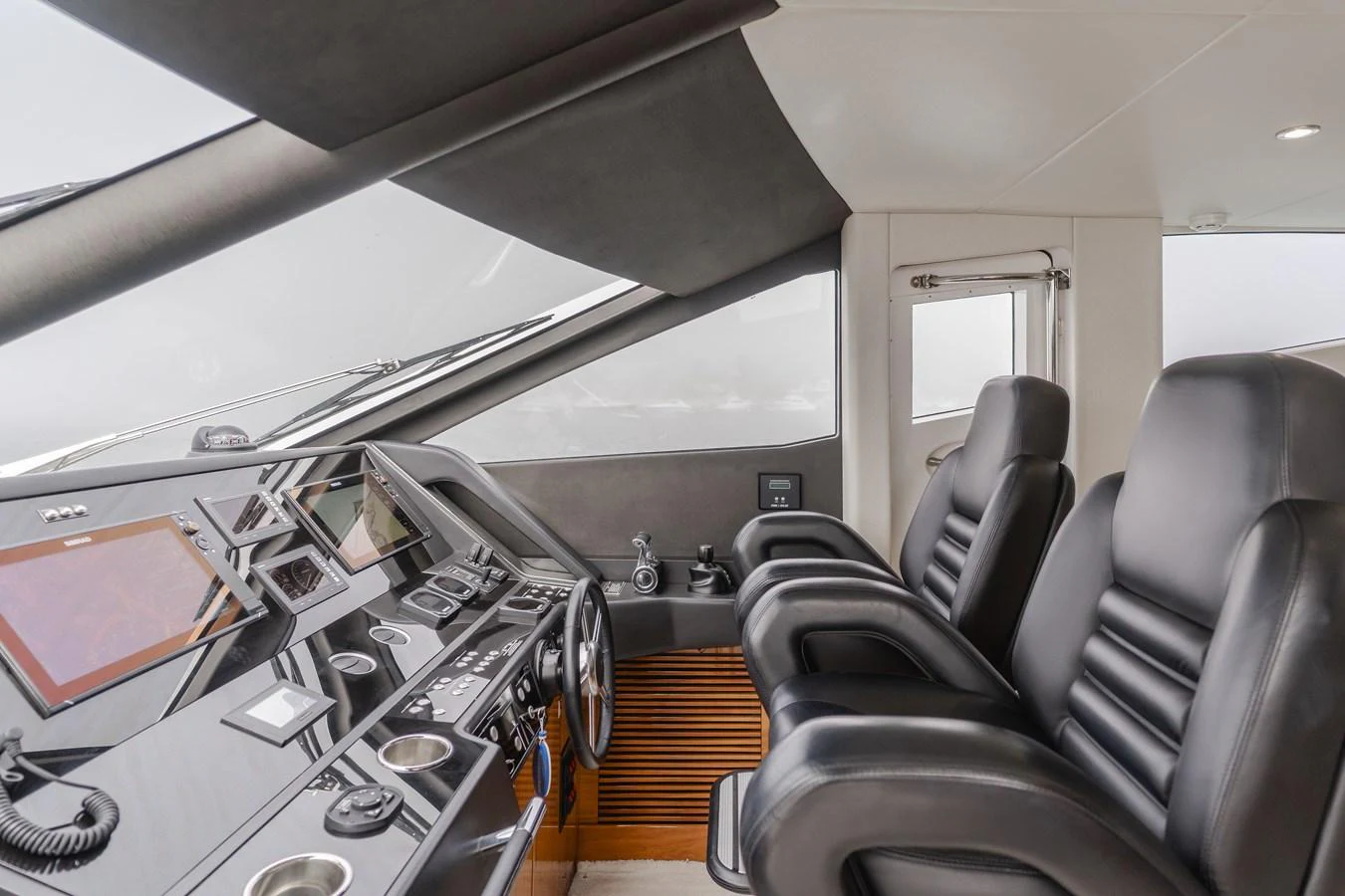 The helm features luxurious black leather seats and a state-of-the-art control panel. aboard AGUA RANCHO Yacht for Sale