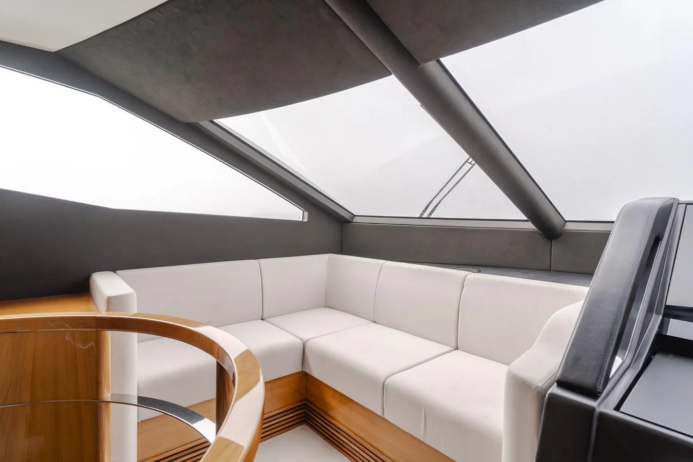 The yacht's interior features a sleek, modern seating area with large windows for ample natural light. aboard AGUA RANCHO Yacht for Sale
