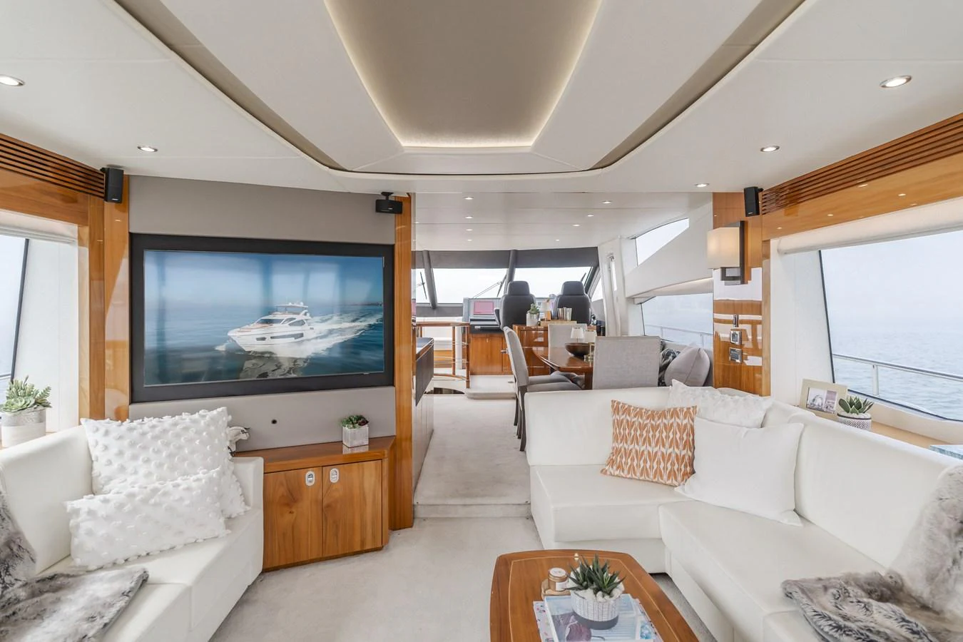 The salon features luxurious seating, a large TV, and ample natural light. aboard AGUA RANCHO Yacht for Sale