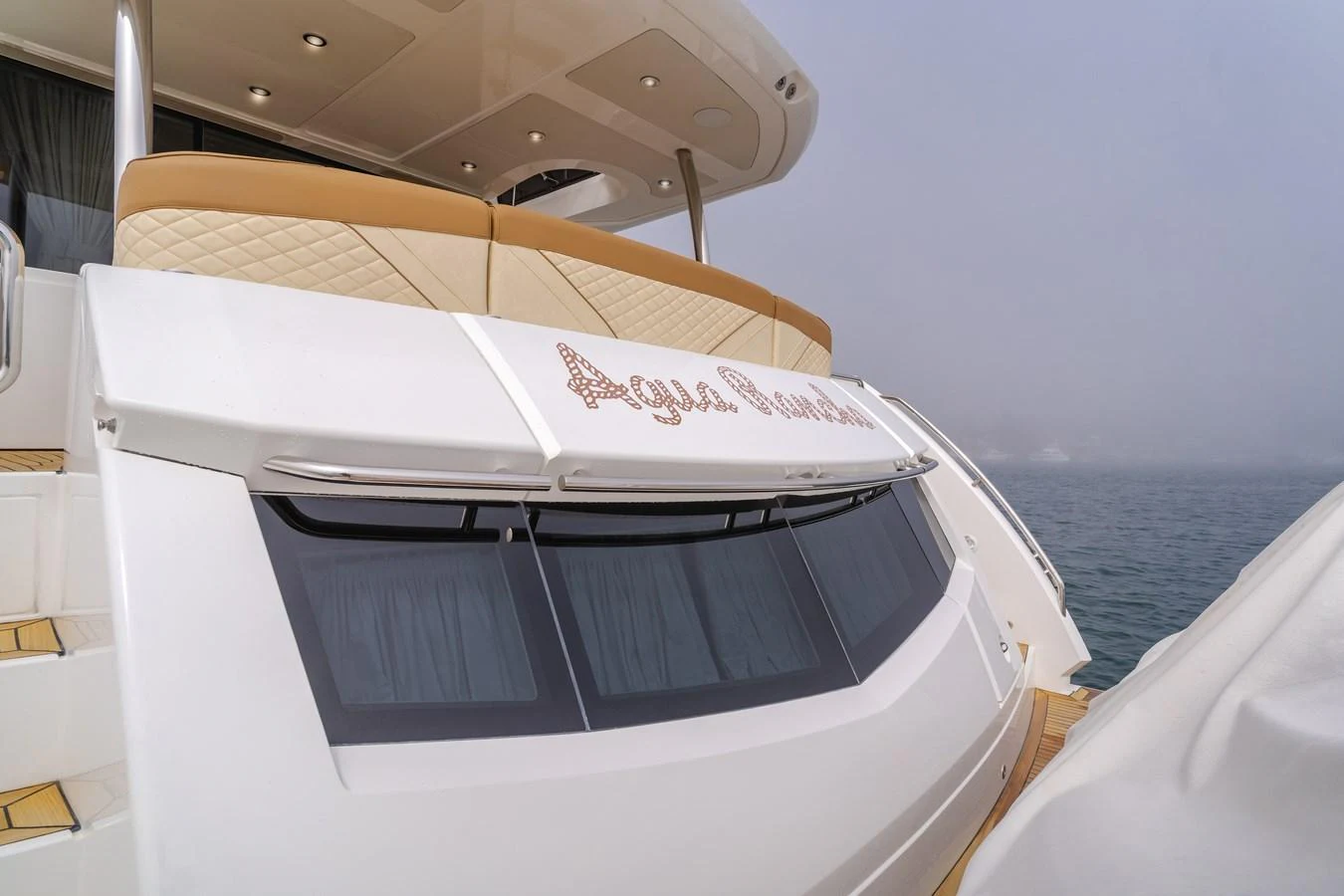 The yacht's sleek aft deck showcases luxurious seating and elegant design details. aboard AGUA RANCHO Yacht for Sale