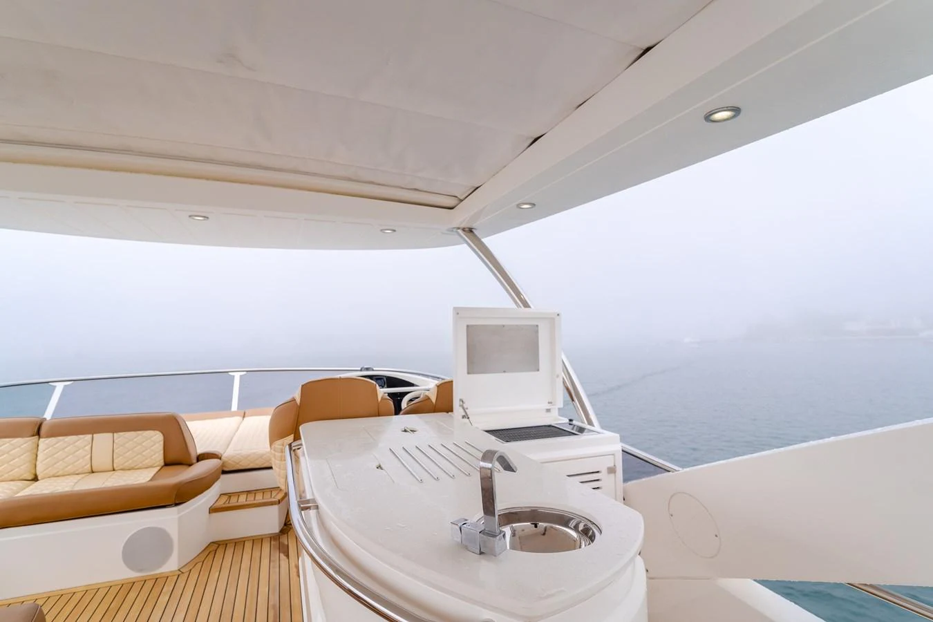 The flybridge features a sleek bar area with comfortable seating and a view of the open water. aboard AGUA RANCHO Yacht for Sale