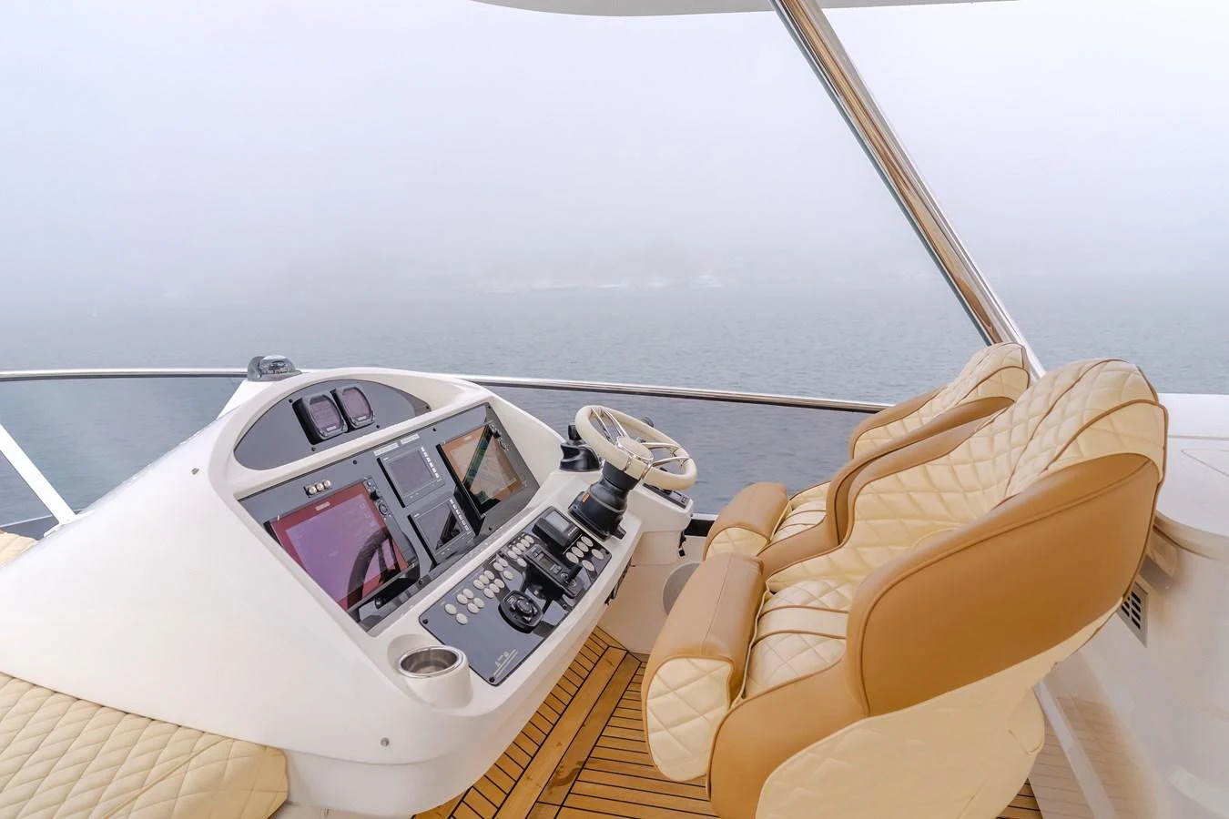 The helm station features luxurious seating and state-of-the-art navigation equipment with a panoramic view. aboard AGUA RANCHO Yacht for Sale