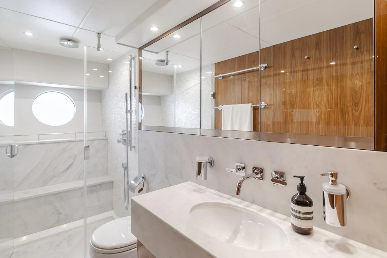 The yacht's bathroom features a sleek design with modern fixtures and ample natural light. aboard AGUA RANCHO Yacht for Sale