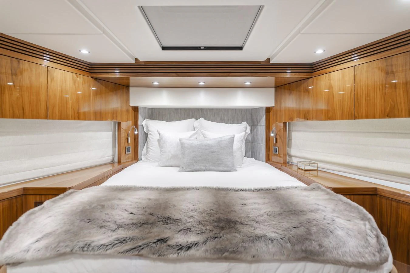 The stateroom features a luxurious bed with plush bedding and elegant wood paneling. aboard AGUA RANCHO Yacht for Sale