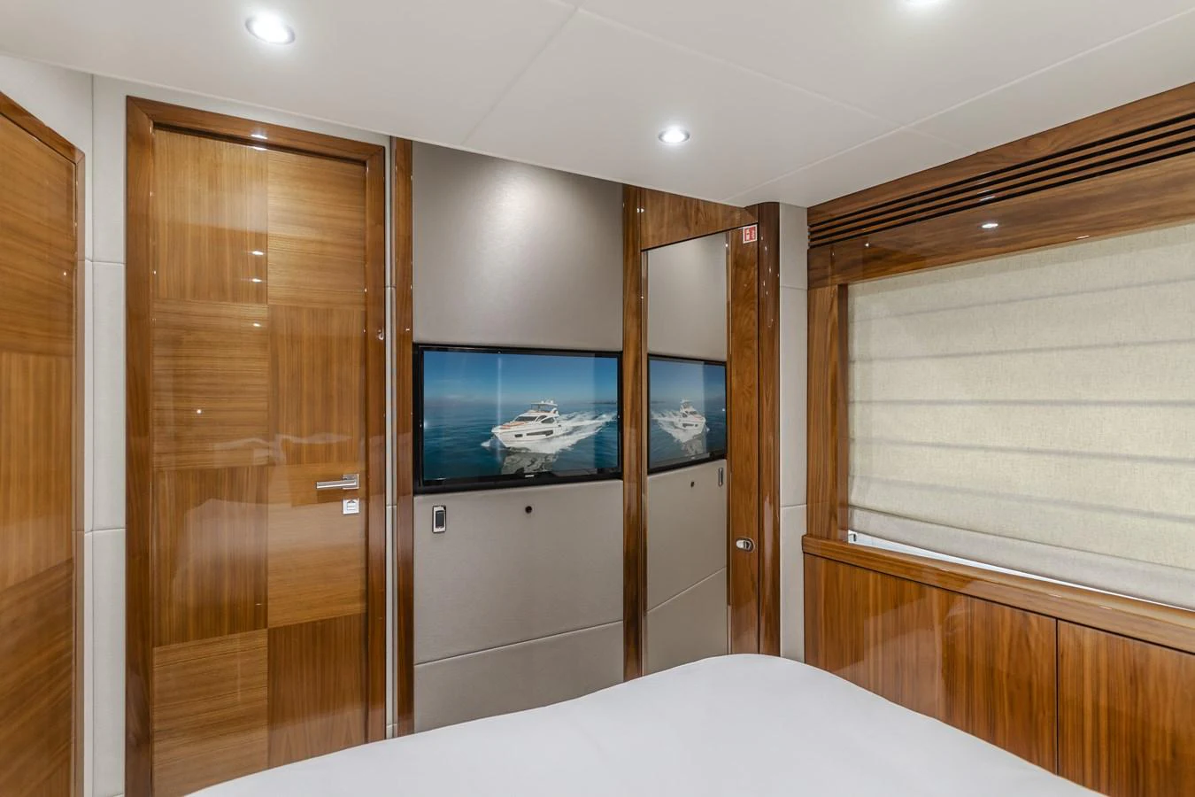 The interior features a modern and elegant design with wooden accents and a flat-screen TV. aboard AGUA RANCHO Yacht for Sale