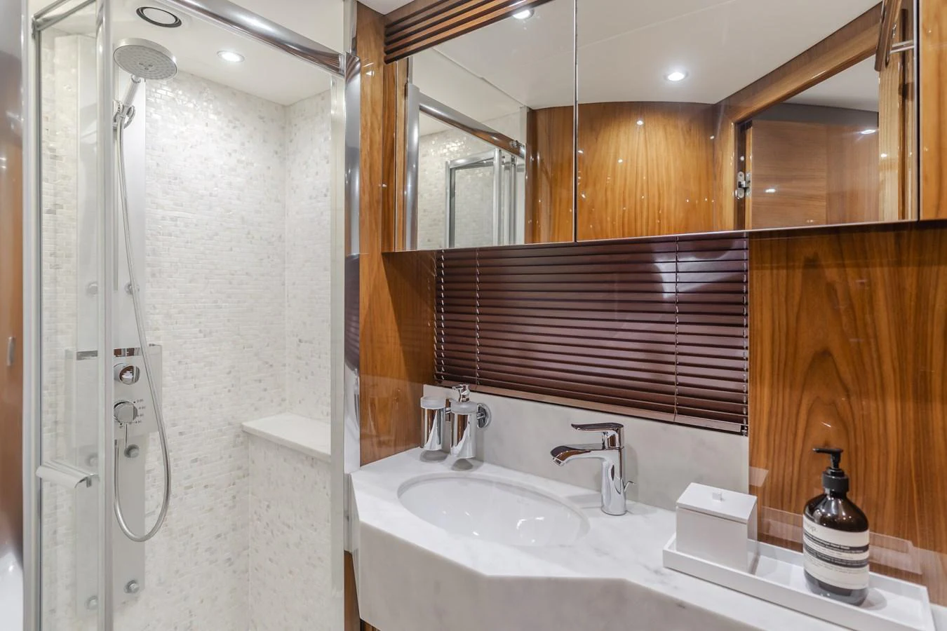 The yacht's bathroom features a sleek design with a modern shower and elegant fixtures. aboard AGUA RANCHO Yacht for Sale