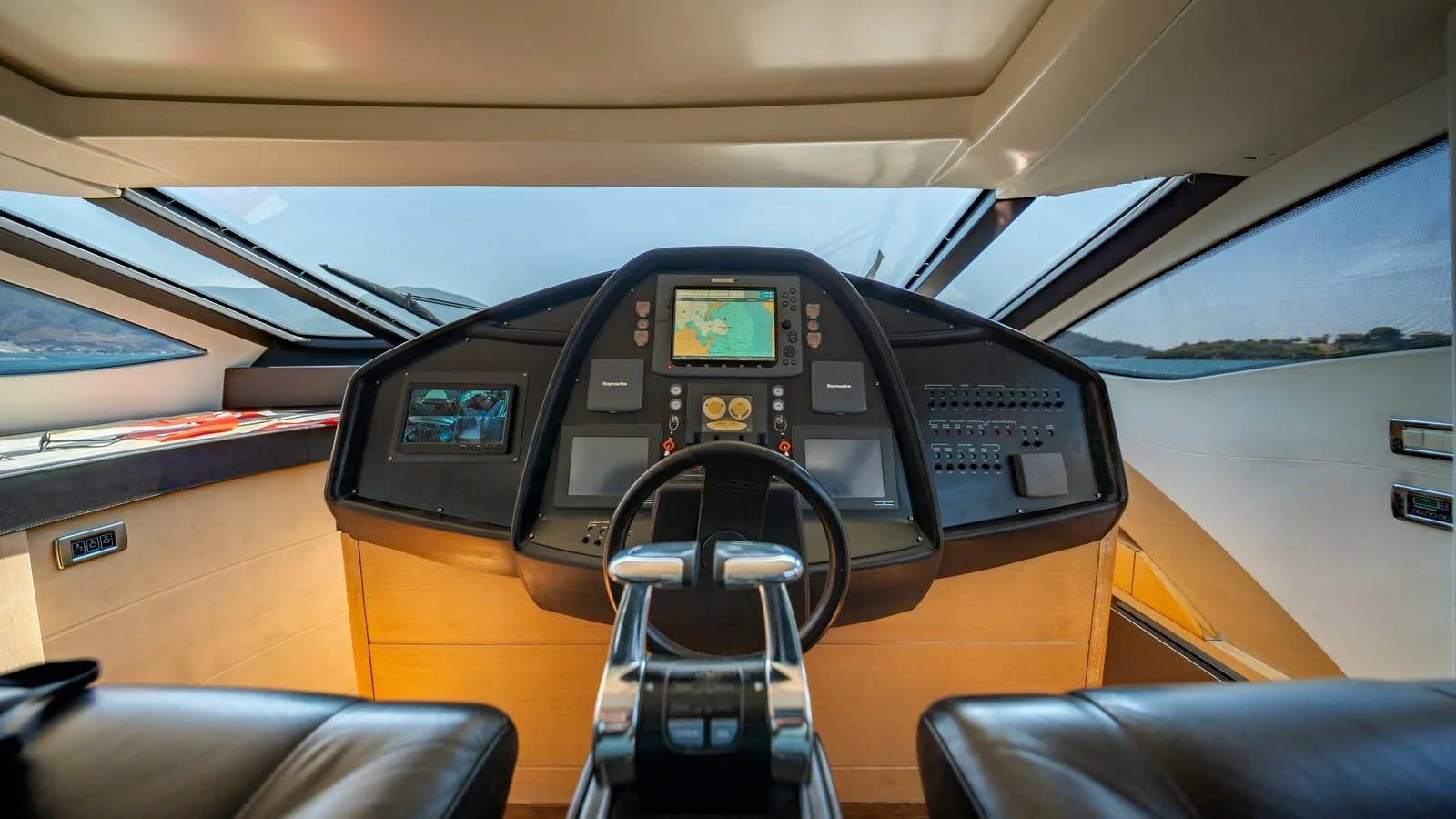 The helm station offers a commanding view with advanced navigation equipment and luxurious finishes. aboard FREEDOM 2 Yacht for Sale