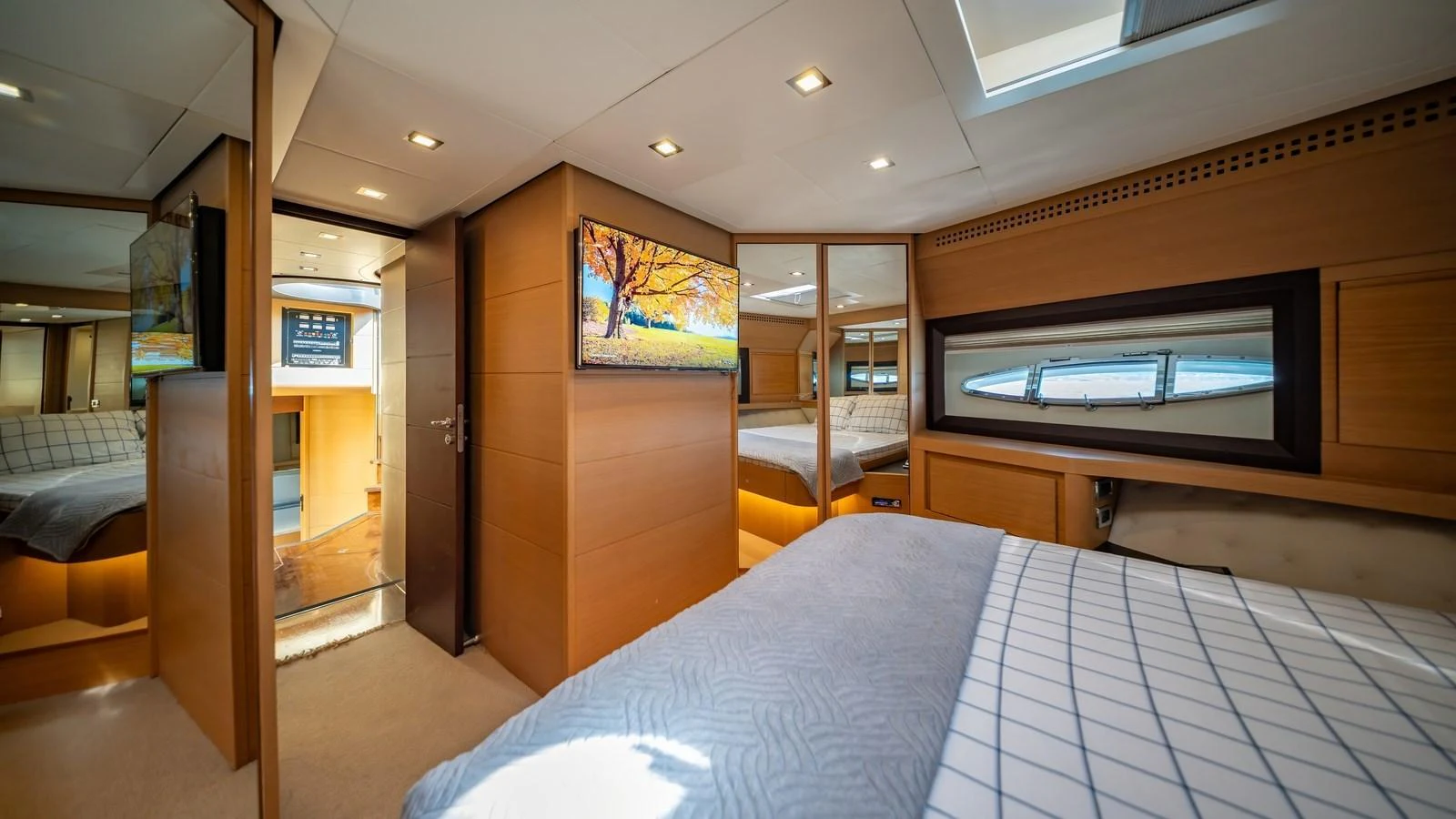 A luxurious stateroom featuring a large bed, modern decor, and ample natural light. aboard FREEDOM 2 Yacht for Sale
