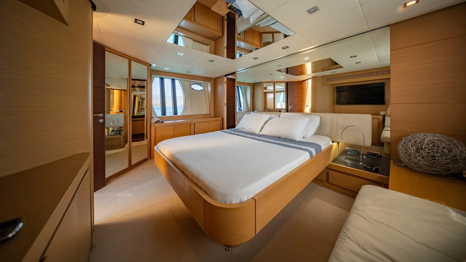 The master stateroom features a spacious bed, elegant wood finishes, and ample natural light. aboard FREEDOM 2 Yacht for Sale