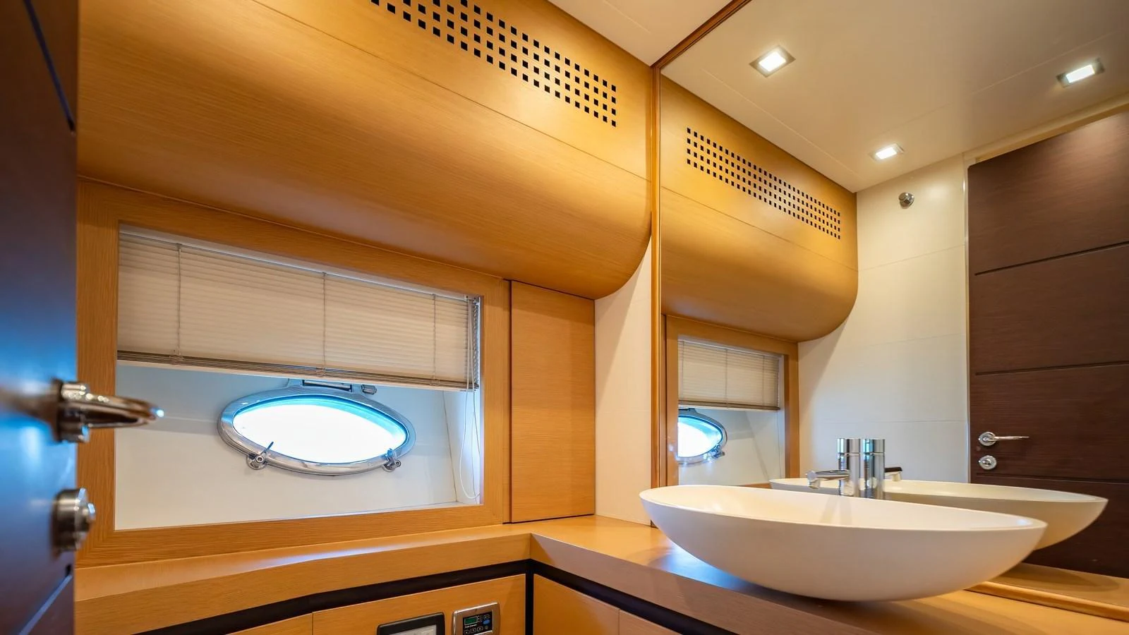 The yacht's bathroom features modern fixtures and warm wood finishes. aboard FREEDOM 2 Yacht for Sale