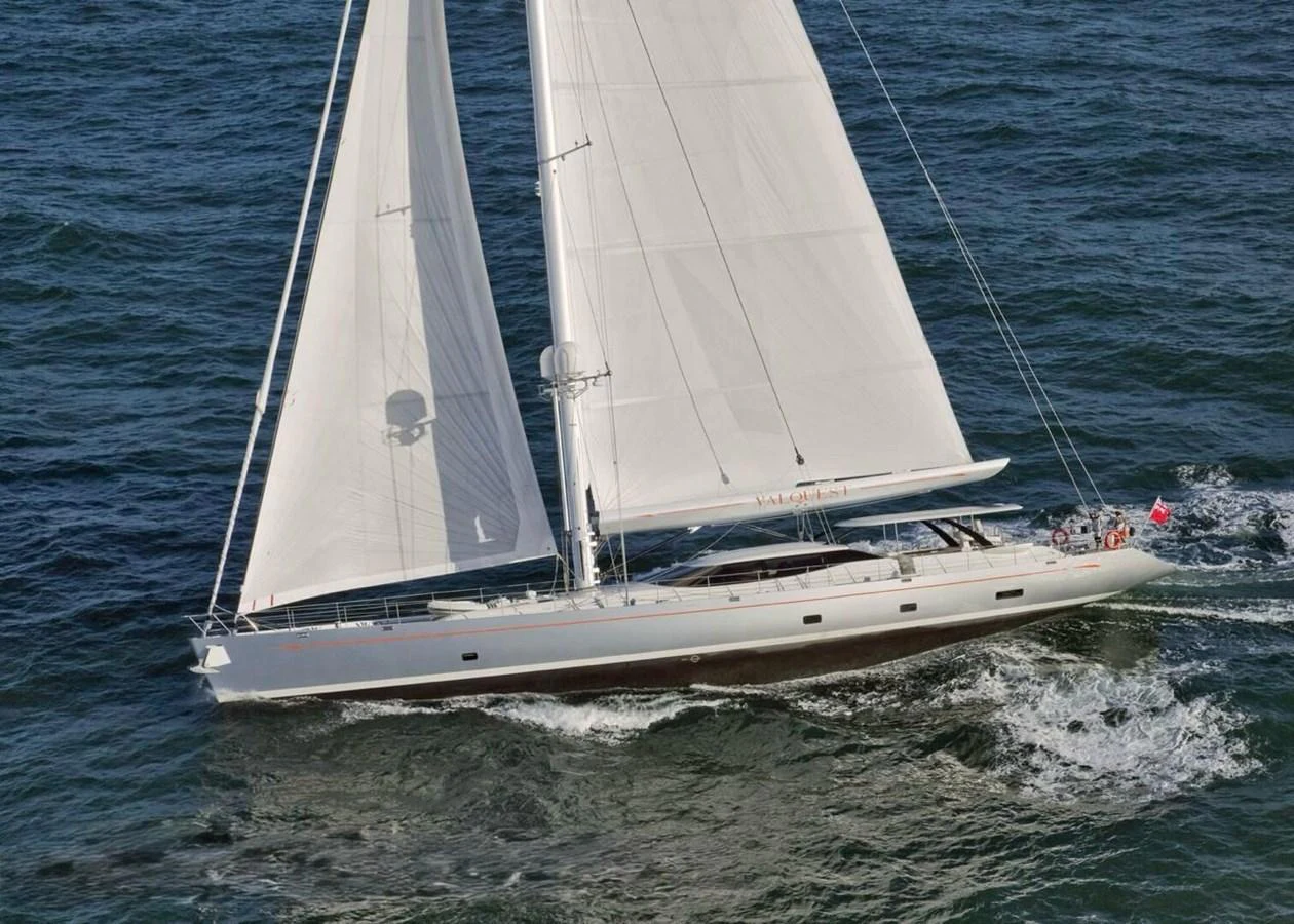 A sleek sailing yacht glides gracefully through the open sea, showcasing its elegant design and impressive sails. aboard VALQUEST Yacht for Sale