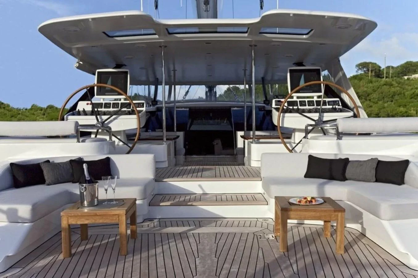 The aft deck features luxurious seating and a sophisticated helm station, perfect for relaxation and navigation. aboard VALQUEST Yacht for Sale