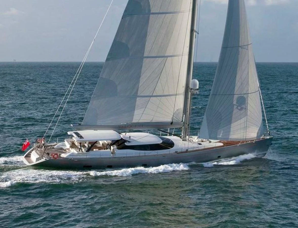 A sleek sailing yacht glides gracefully over the water with full sails. aboard VALQUEST Yacht for Sale