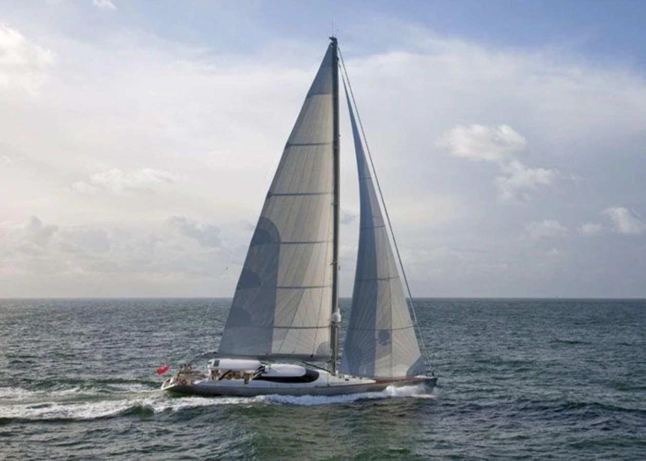 A sleek sailing yacht glides gracefully over the water under full sail. aboard VALQUEST Yacht for Sale