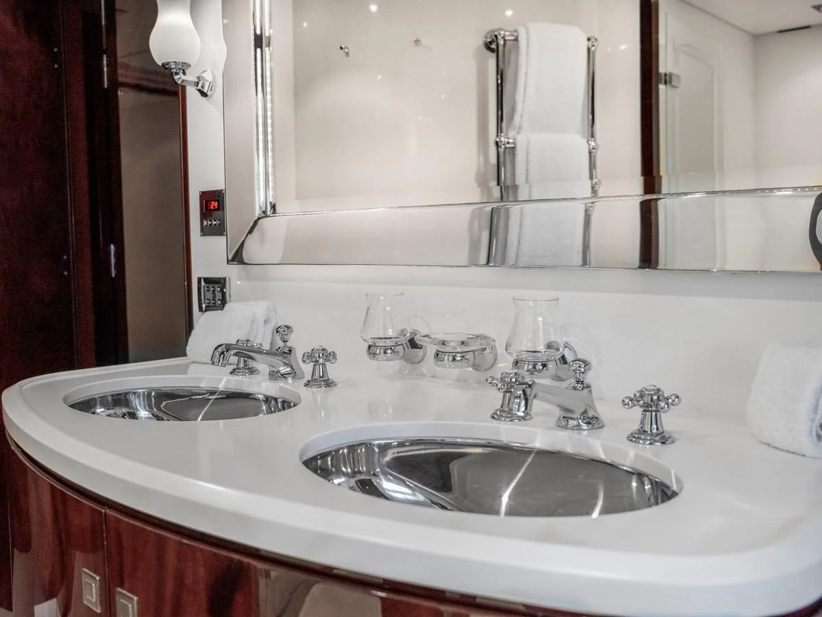 The yacht's bathroom features a luxurious double sink vanity with elegant fixtures. aboard VALQUEST Yacht for Sale