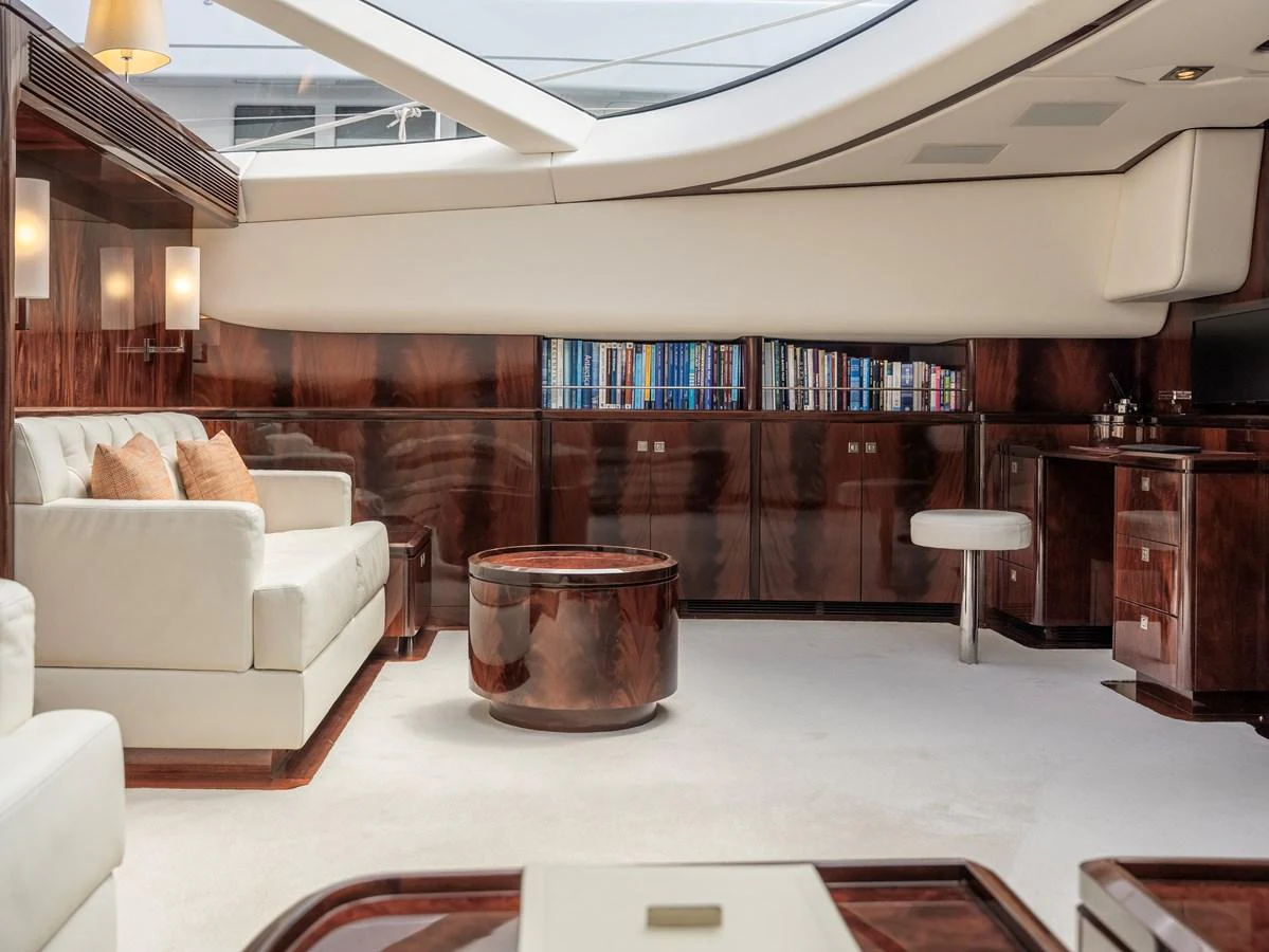 The yacht's interior features a luxurious seating area with elegant wooden finishes and ample natural light. aboard VALQUEST Yacht for Sale