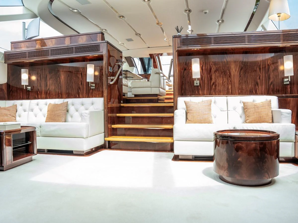 The salon features luxurious seating with elegant wood finishes and ample natural light. aboard VALQUEST Yacht for Sale