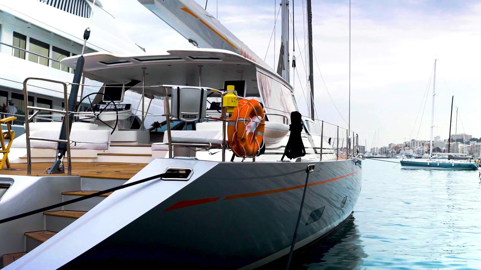 A sleek and modern yacht docked at a marina, showcasing its elegant lines and sophisticated design. aboard VALQUEST Yacht for Sale