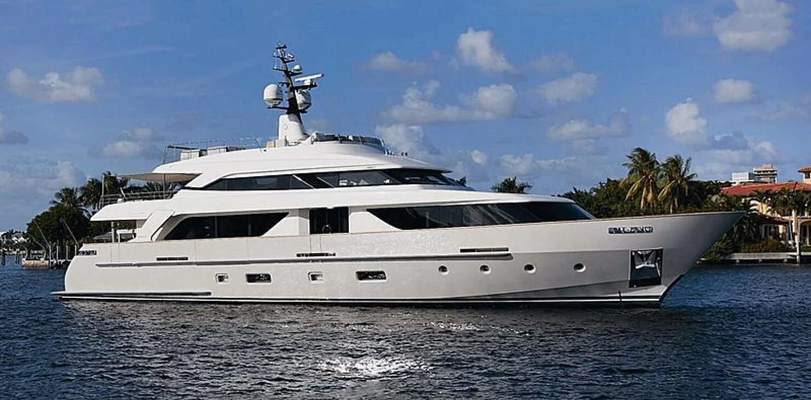 A sleek and modern yacht cruising on calm waters under a clear blue sky. aboard CHRISTINA Yacht for Sale