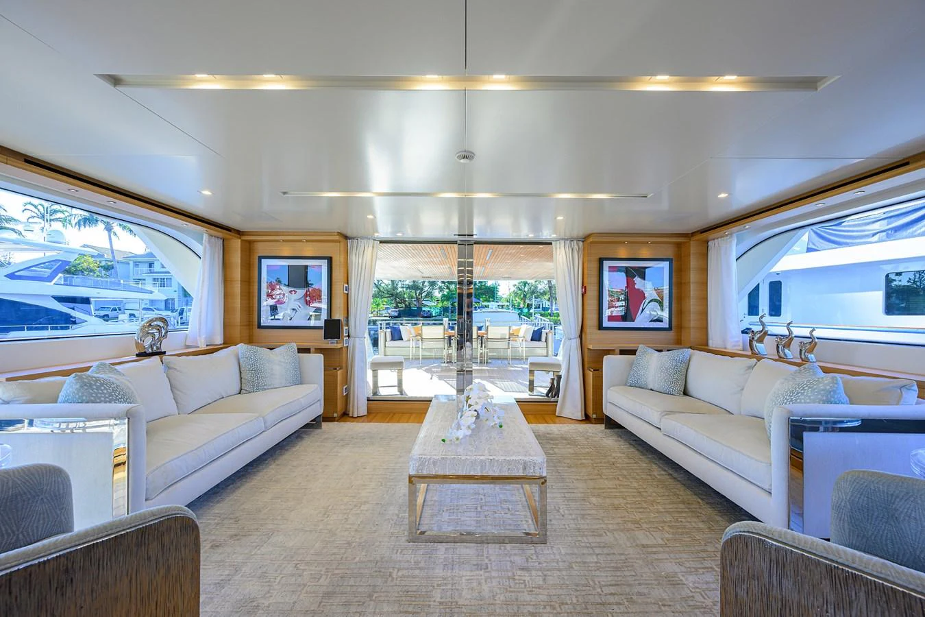The salon features elegant seating with large windows offering a bright and inviting atmosphere. aboard CHRISTINA Yacht for Sale