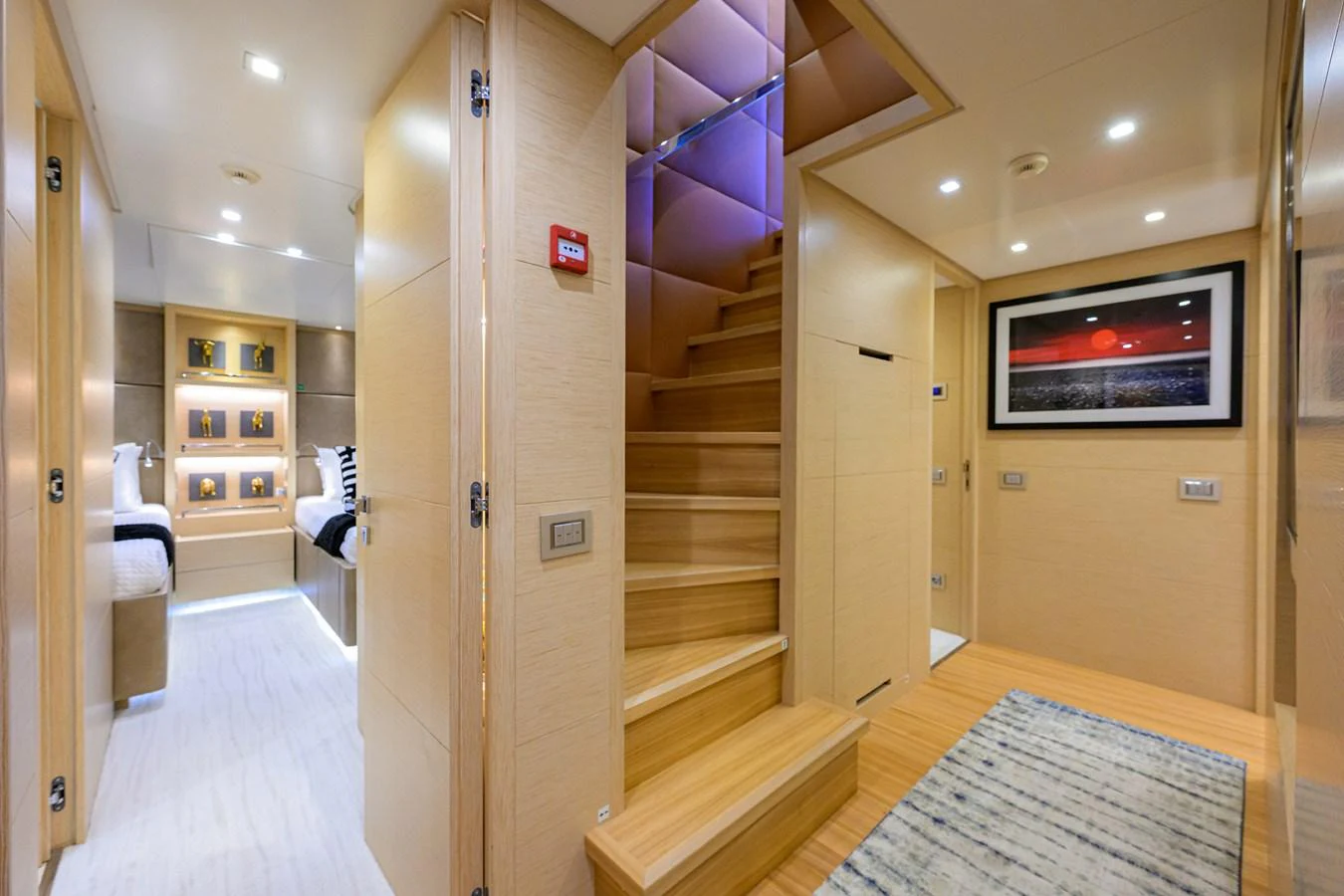 The interior of the yacht features a modern staircase with adjacent rooms and elegant decor. aboard CHRISTINA Yacht for Sale