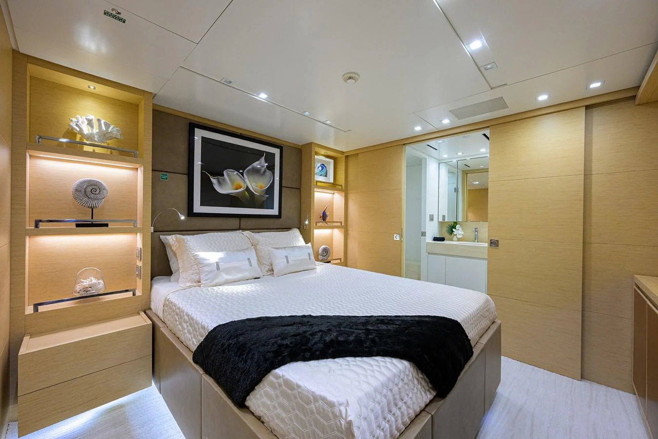 The stateroom features a luxurious bed with elegant decor and ample lighting. aboard CHRISTINA Yacht for Sale