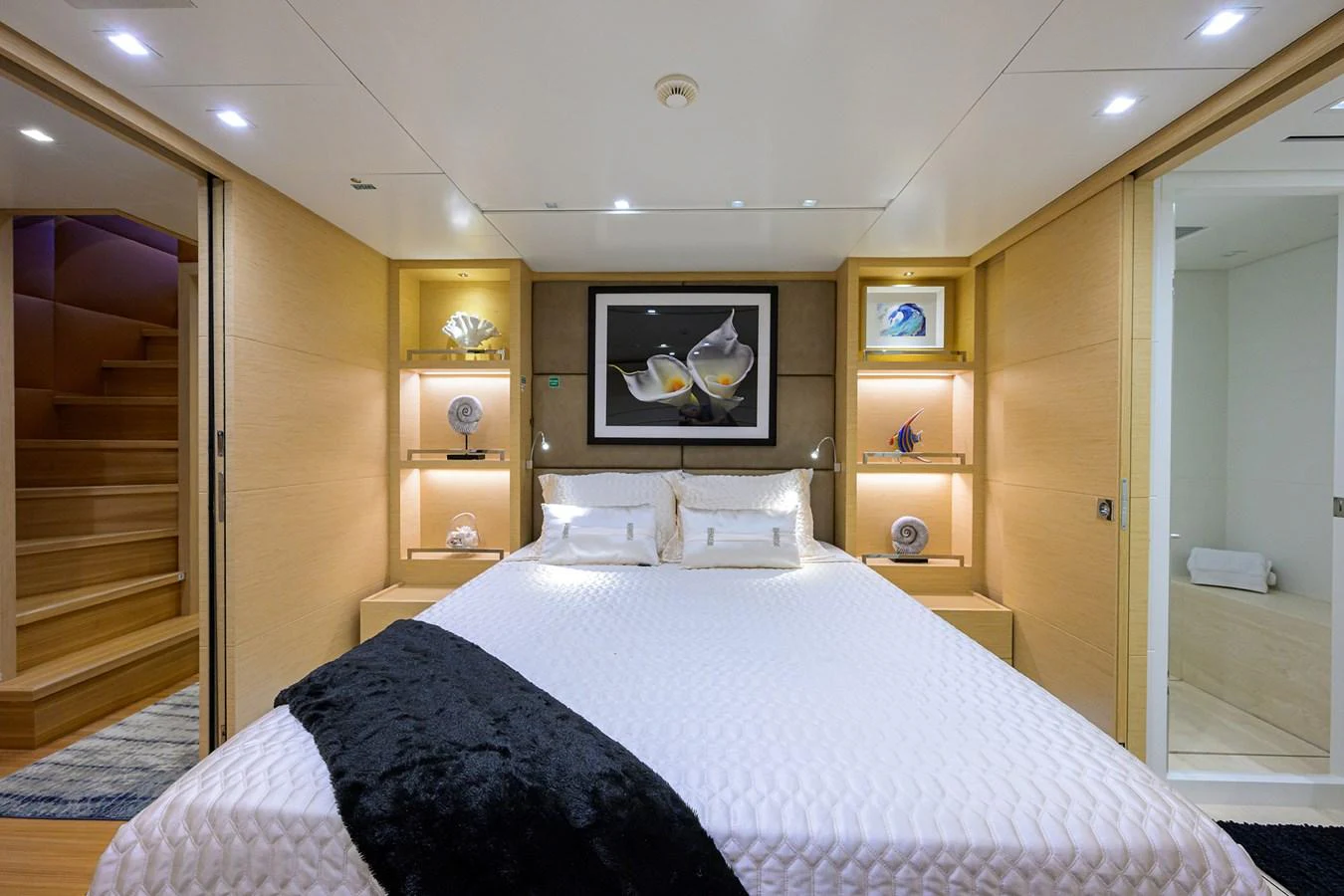 The stateroom features a luxurious bed with elegant decor and soft lighting. aboard CHRISTINA Yacht for Sale