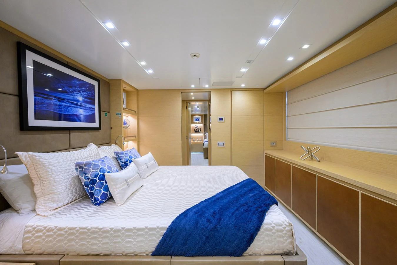 The stateroom features a plush bed with elegant bedding and modern decor, creating a serene and luxurious atmosphere. aboard CHRISTINA Yacht for Sale