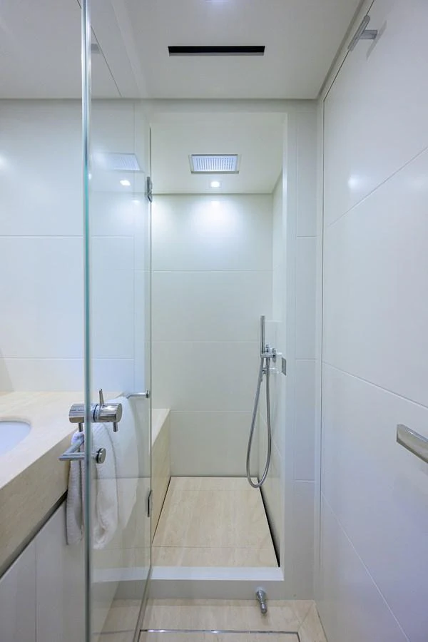 The yacht's bathroom features a sleek, modern design with a glass shower enclosure and elegant fixtures. aboard CHRISTINA Yacht for Sale