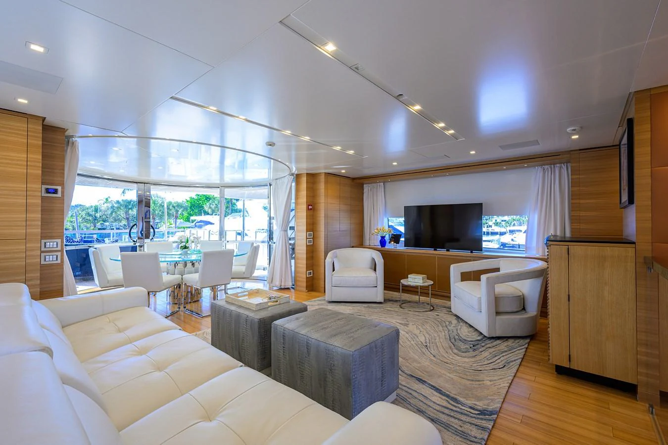 The salon offers a spacious and luxurious seating area with modern furnishings and ample natural light. aboard CHRISTINA Yacht for Sale