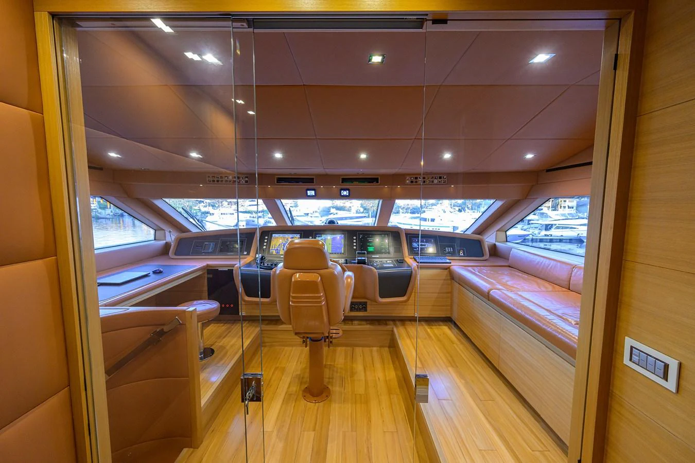 The helm station features a sophisticated control area with plush seating and panoramic views. aboard CHRISTINA Yacht for Sale