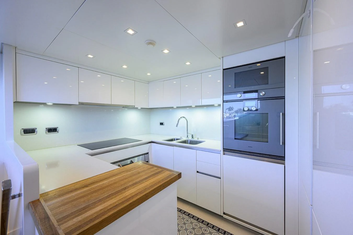 The modern galley features sleek white cabinetry, high-end appliances, and ample counter space. aboard CHRISTINA Yacht for Sale