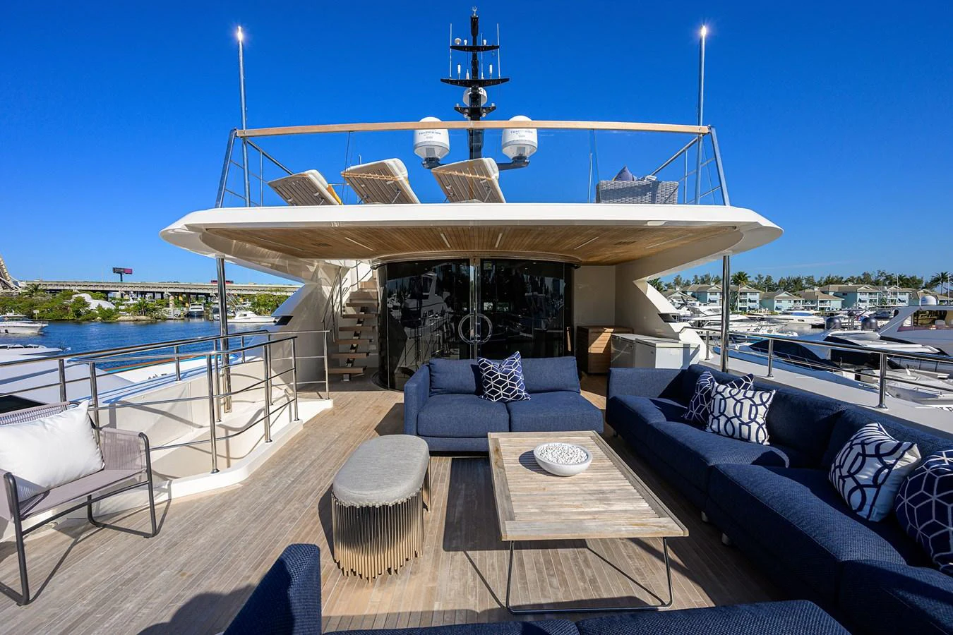 The yacht's aft deck features a spacious and stylish outdoor lounge area with comfortable seating and a beautiful view. aboard CHRISTINA Yacht for Sale