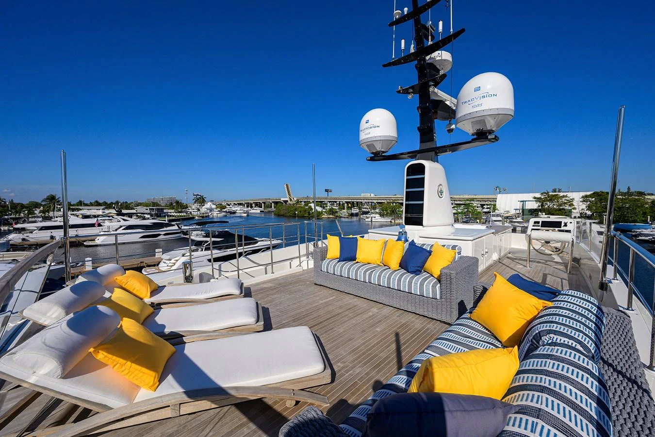 The sundeck features luxurious lounge chairs and vibrant cushions, perfect for relaxation under the sun. aboard CHRISTINA Yacht for Sale