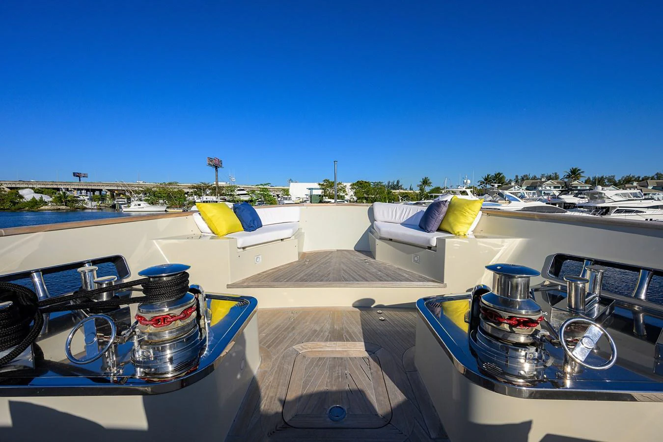 The foredeck features comfortable seating with vibrant cushions and polished winches, perfect for relaxation and enjoying the view. aboard CHRISTINA Yacht for Sale